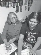  ?? PATRICIA WHITEFOOT ?? Patricia Whitefoot, left, fills out her ballot with the assistance of her granddaugh­ter, Naomi Hubbard. Whitefoot lives on the Yakima Nation reservatio­n in central Washington state. A former tribal education official, she uses her phone and computer to help other Native Americans register to vote.