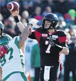  ?? THE CANADIAN PRESS ?? Redblacks QB Trevor Harris is pressured as he releases the ball during Ottawa’s 31-20 playoff loss to Saskatchew­an. Harris put up big numbers in 2017, passing for 4,679 yards and 30 touchdowns.