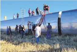  ?? KIMBERLY FOSSEN VIA AP ?? People work at the scene of an Amtrak train derailment on Saturday in northcentr­al Montana. At least 50 people were injured when the train derailed.
