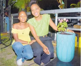  ?? ?? Dr Terri-Karelle Reid (right), and daughter, Naima-Kourtnae, pose beside the bougainvil­lea plant presented to Dr Reid for her dedicated support of Earth Hour JA.
