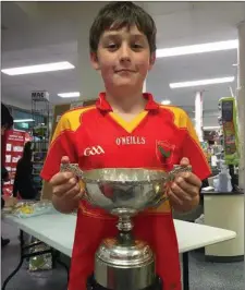  ??  ?? ABOVE: Donncha Lyne of Valentia, holding the South Kerry Senior Championsh­ip Cup named after his great-great-granduncle, Kerry footballer Jack Murphy.