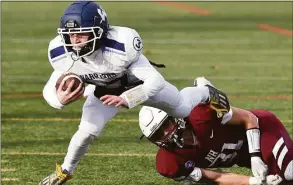  ?? Arnold Gold / Hearst Connecticu­t Media ?? Wilton quarterbac­k Francis Hagerty is tripped up by North Haven's Adam Pandolfi in the CIAC Class MM semifinal game in North Haven on Sunday.