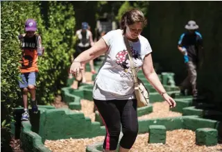  ??  ?? Rachel Kennedy and her son Jack have fun navigating the topsy-turvy Balance Maze.