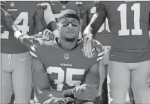  ?? MARCIO JOSE SANCHEZ/AP PHOTO ?? In this Sept. 10, 2017, file photo, San Francisco 49ers safety Eric Reid (35) kneels in front of teammates during the playing of the national anthem before al game against the Carolina Panthers.