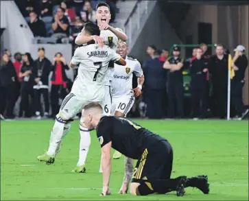  ?? Wally Skalij Los Angeles Times ?? JEFFERSON SAVARINO celebrates the go-ahead goal with Damir Kreilach. LAFC’s Jordan Harvey is down.