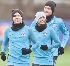 ??  ?? Cesc Fabregas (left), Pedro and Marcos Alonso attend a training session at Chelsea’s Cobham training facility in Stoke D’Abernon, southwest of London on the eve of their UEFA Champions League Group C football match against Atletico Madrid. — AFP photo