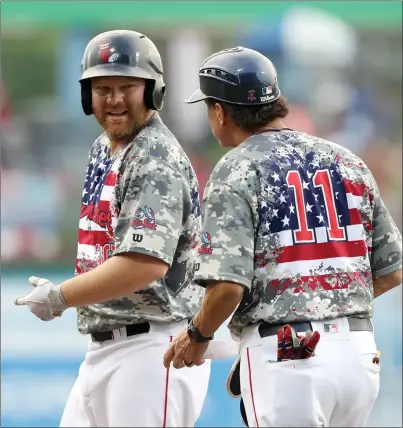  ?? Photo by Louriann Mardo-Zayat / lmzartwork­s.com ?? Even though he hit .324 with three home runs and 11 RBIs in his last 11 games with the PawSox, first baseman Adam Lind (left) couldn’t find an MLB team to take his services. Lind decided to return to the PawSox to finish the season.