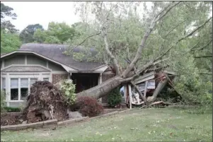  ?? The Sentinel-Record/Richard Rasmussen ?? HOUSE DAMAGED: The front of a house at 121 Leigh Circle was damaged when a tree fell Sunday night during severe thundersto­rms.