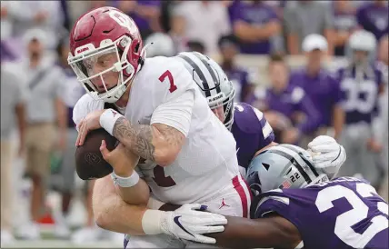  ?? ORLIN WAGNER / AP ?? Oklahoma quarterbac­k Spencer Rattler (7) secures the ball while being tackled by Kansas State defenders Julius Brents (23) and Eli Huggins (92) on Saturday in Manhattan, Kan. This weekend, Oklahoma travels to Dallas for the annual Red River Showdown against Texas.