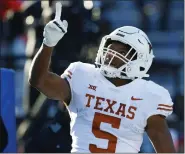  ?? COLIN E. BRALEY — THE ASSOCIATED PRESS FILE ?? Texas running back Bijan Robinson reacts after scoring against Kansas during the first half on Nov. 19, 2022, in Lawrence, Kan. Robinson was selected to The Associated Press All-America team this past season.
