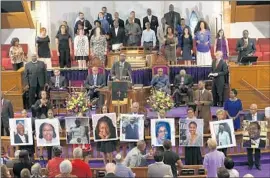  ?? Win McNamee
Getty Images ?? WASHINGTON, D.C.: Photos of the nine people killed at a Charleston, S.C., church are displayed at a prayer vigil Friday at Metropolit­an AME Church.