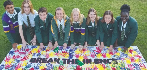  ?? ?? MANY HANDS: Centenary Heights State High School students (from left) Tirth Panchal, Ryan Maynard, Dylan Hickey, Amy Skerman, Erica Wilson, Mia Jago, Ryleigh Parsons and Helen Jukuda, at the Toowoomba Domestic Violence Remembranc­e Ceremony and Walk.