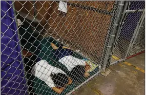  ?? AP/ROSS D. FRANKLIN ?? This photo of two female detainees sleeping in a holding cell in Nogales, Ariz., is one of several taken in 2014 that activists used as examples of current immigratio­n policies.