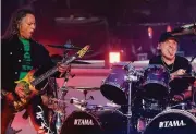  ?? Torben Christense­n / Associated Press ?? Kirk Hammett (left) and Lars Ulrich perform with Metallica last month at a festival in Copenhagen.