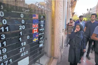  ?? VAHID SALEMI/ASSOCIATED PRESS ?? An exchange shop in downtown Tehran, Iran, displays rates for various currencies. Some in the U.S. Congress are concerned that sanctions to be re-imposed on Iran early next month won’t be tough enough.