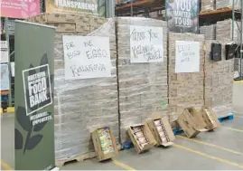  ?? DAVID SHAROS/BEACON-NEWS ?? Crates of Eggo waffles wait to be broken down and packed Thursday at the Northern Illinois Food Bank in Geneva. A total of 180,000 waffles and a $5,000 check were donated to the food bank by Eggo.