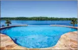  ??  ?? Left: Perfect for outdoor living, the grilling pavilion offers a sink, work counters and a built-in grill. Right: Surrounded by stone decking, this in  nity pool overlooks beautiful Hurricane Lake.