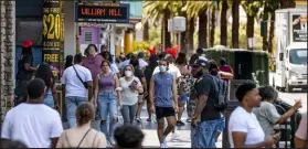  ?? Las Vegas Review-Journal @Left_Eye_Images ?? L.E. Baskow
People walk July 16 along the Strip near The Venetian, most not wearing masks. Employees must wear masks indoors through at least Aug. 17 amid worsening COVID-19 metrics.