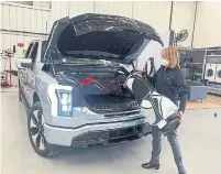  ?? MARK PHELAN TRIBUNE NEWS SERVICE ?? Junk in the frunk: The 2022 Ford F-150 Lightning electric pickup’s front storage compartmen­t can hold two golf bags.