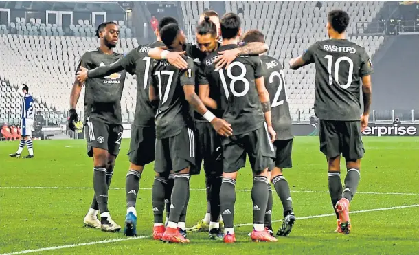  ??  ?? Manchester United’s Bruno Fernandes (18) celebrates with team-mates after scoring his side’s opening goal against Real Sociedad in Turin.