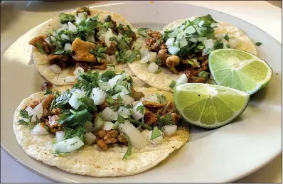  ?? Arkansas Democrat-Gazette/ERIC E. HARRISON ?? Three Tacos al Pastor are a reasonable $5 at Three Amigo’s Restaurant­e on Cantrell Road in Little Rock.