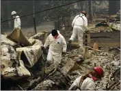  ?? JOHN LOCHER — THE ASSOCIATED PRESS FILE ?? Search and rescue workers search for human remains at a trailer park burned out from the Camp Fire in Paradise.