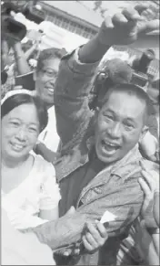  ?? Khin Maung Win ?? A PRISONER waves jubilantly after his release in Yangon. The U.S. plans to send an envoy to Myanmar, also known as Burma, for the first time since 1990, and it invited Myanmar to reciprocat­e.