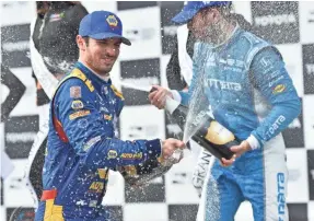  ?? CHRIS OWENS/VERIZON INDYCAR SERIES ?? Alexander Rossi sprays the champagne on third-place finisher Ed Jones in victory circle after winning the Grand Prix of Long Beach in 2018.