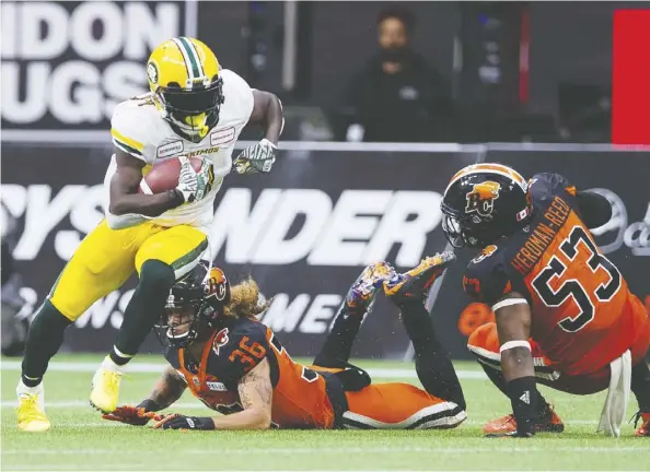  ??  ?? Eskimos receiver Natey Adjei evades Lions defenders Aaron Grymes and Jordan Herdman-reed as he turns upfield after making a catch in Edmonton’s lopsided 33-6 victory on Thursday night in Vancouver. Adjei had four catches for 106 yards and a touchdown. Gerry Kahrmann