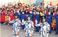  ?? ?? Payload expert Gui Haichao (left), space flight engineer Zhu Yangzhu (centre) and commander Jing Haipeng at the Jiuquan Satellite Launch Centre in China’s northweste­rn Gansu province on Tuesday. — afp