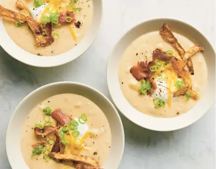  ?? DAVID MALOSH/THE NEW YORK TIMES ?? Twice-baked potato soup is homey, comforting and — just like a baked potato — all about the toppings.