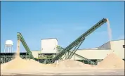  ??  ?? Machinery pumps out lumber byproducts in the form of sawdust and wood chips at the El Dorado, Ark., mill.