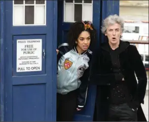  ?? The Associated Press ?? British actor Peter Capaldi, in costume as Doctor Who, and Pearl Mackie as his new companion Bill Potts, pose with a replica of the TARDIS, to promote the new Doctor Who TV series Wednesday on the Southbank in London. After three seasons of zooming...