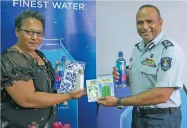  ??  ?? Fiji Police Commission­er Brigadier Sitiveni Qiliho (right) receiving care packs from FIJI Water Foundation manager Marie Smith (left) at the Police Headquarte­rs.