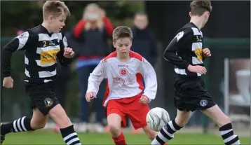  ??  ?? Declan Curtin attempts to weave past Kyle Watters and Dillon Cahill.