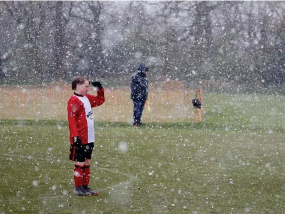  ?? (Reuters) ?? April snow showers yesterday in Altrincham, Greater Manchester