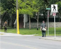  ?? GAVIN YOUNG/ POSTMEDIA NEWS FILES ?? TODAY: Pedestrian­s traverse 25th Avenue S. W. in Calgary a year after the Elbow River flooded the neighbourh­ood.