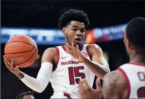  ?? NWA Democrat-Gazette/J.T. WAMPLER ?? Arkansas’ Mason Jones looks to pass to Reggie Chaney against Southweste­rn Oklahoma State on Friday at Bud Walton Arena.