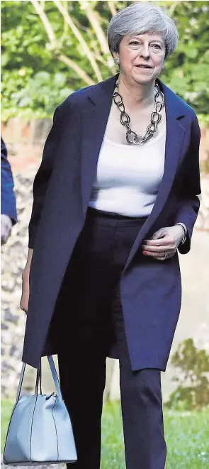  ??  ?? Theresa May goes to church yesterday in her Maidenhead constituen­cy