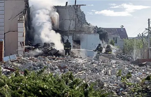  ?? ?? AFTERMATH: Rescuers are seen at work at a house after a Russian missile attack in Ukraine’s Kharkiv region.