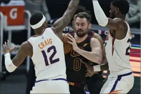  ?? TONY DEJAK — THE ASSOCIATED PRESS ?? Kevin Love tries to get past the Suns’ Torrey Craig and Deandre Ayton during the first half May 4at Rocket Mortgage FieldHouse.