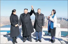 ?? PYEONGYANG PRESS CORPS ?? North Korea’s Kim Jong Un and his wife, Ri Sol Ju, left, pose with South Korea’s President Moon Jae-in and his wife, Kim Jung-sook, on top of Mount Paektu in North Korea on Thursday.