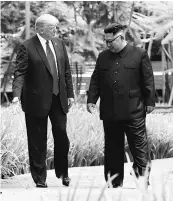  ?? PHOTO: REUTERS ?? US President Donald Trump (left) and North Korea leader Kim Jong-un walk after lunch at the Capella Hotel in Singapore on Tuesday