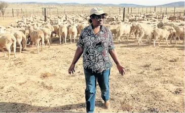  ?? Picture: THE HERALD/BRIAN WITBOOI ?? IN HER VEINS: Nomvula Feni tends her flock on her Westondale Farm in Pearston.