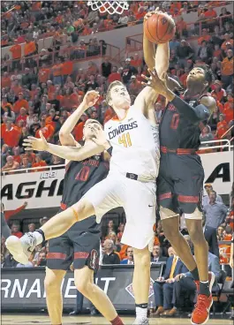  ?? NATE BILLINGS — THE OKLAHOMAN VIA AP ?? Stanford’s Michael Humphrey, left, and KZ Okpala battle with Oklahoma State’s Mitchell Solomon for a rebound during their NIT tournament game in Stillwater, Oklahoma.