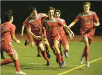  ?? APRIL GAMIZ/THE MORNING CALL ?? Parkland’s Josh Daniels reacts with his teammates after scoring the winning goal against Emmaus on Thursday in the District 11 4A boys championsh­ip game at J. Birney Crum Stadium.