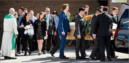  ?? Herald photo by Ian Martens @IMartensHe­rald ?? Pallbearer­s carry the casket of Logan Boulet to the waiting hearse, followed by Logan’s parents Toby and Bernadine and sister Mariko, following the celebratio­n of life service Saturday afternoon at Nicholas Sheran Arena.