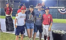  ?? COURTESY OF THE ANTOLIK FAMILY ?? Dana Yoo, center left, poses, left to right, with her son Caius, husband Chris and son Marcus at a tournament in Cooperstow­n, New York, during the summer of 2022.