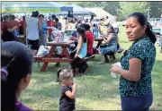  ?? Photos by Diane Wagner, Rome News-Tribune ?? BELOW: Felisa Vicente (right) has a welcoming smile for her daughter Brittney Vicente (left), 10, as her youngest daughter Daleyza Perez, 2, sucks on some ice at the patriotic festival.