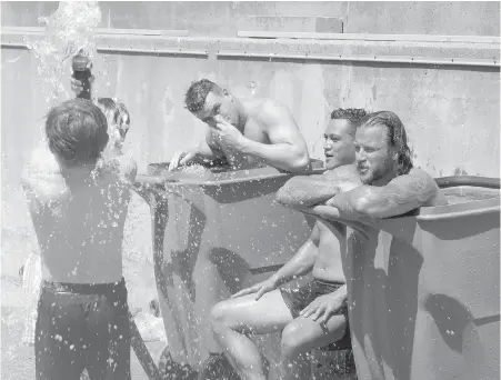  ?? NEIL DAVIDSON, CP ?? Toronto Wolfpack rugby players cool off after their practice at Lamport Stadium in Toronto on Wednesday.